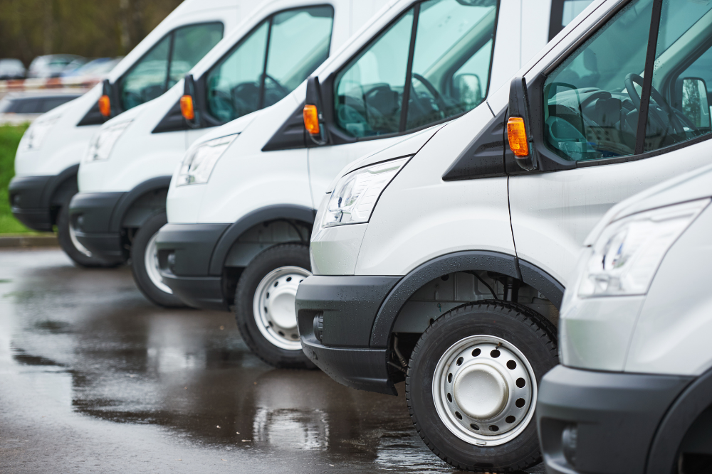 Fleet Maintenance in Westfield, MA at LaFlamme's Auto & Truck Services. Line of white commercial fleet vehicles lined up outside