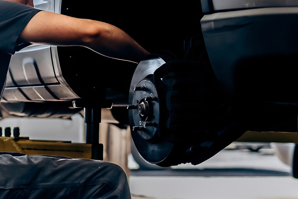 Brake Repair and Suspension Service in Westfield, MA At LaFlamme's Auto & Truck Services. Auto technician performing brake and suspension repair on a vehicle lift